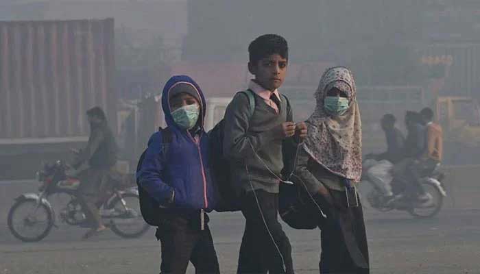 Children walk to school amid heavy smog conditions in Lahore on December 1, 2022.