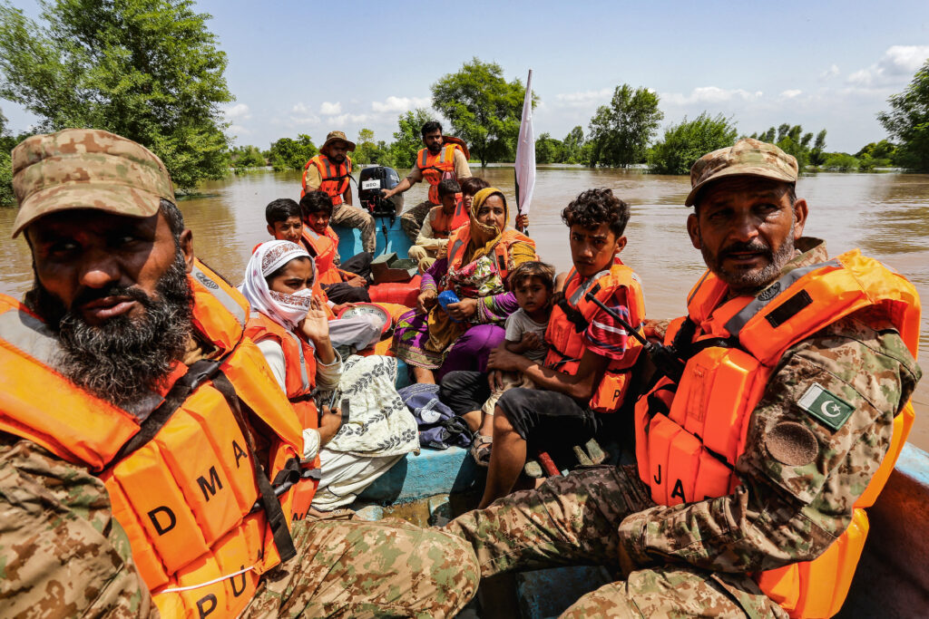Pakistani soldiers use a boat to evacuate flood-hit residents from Muzaffargarh district in Punjab province, September 3, 2025.