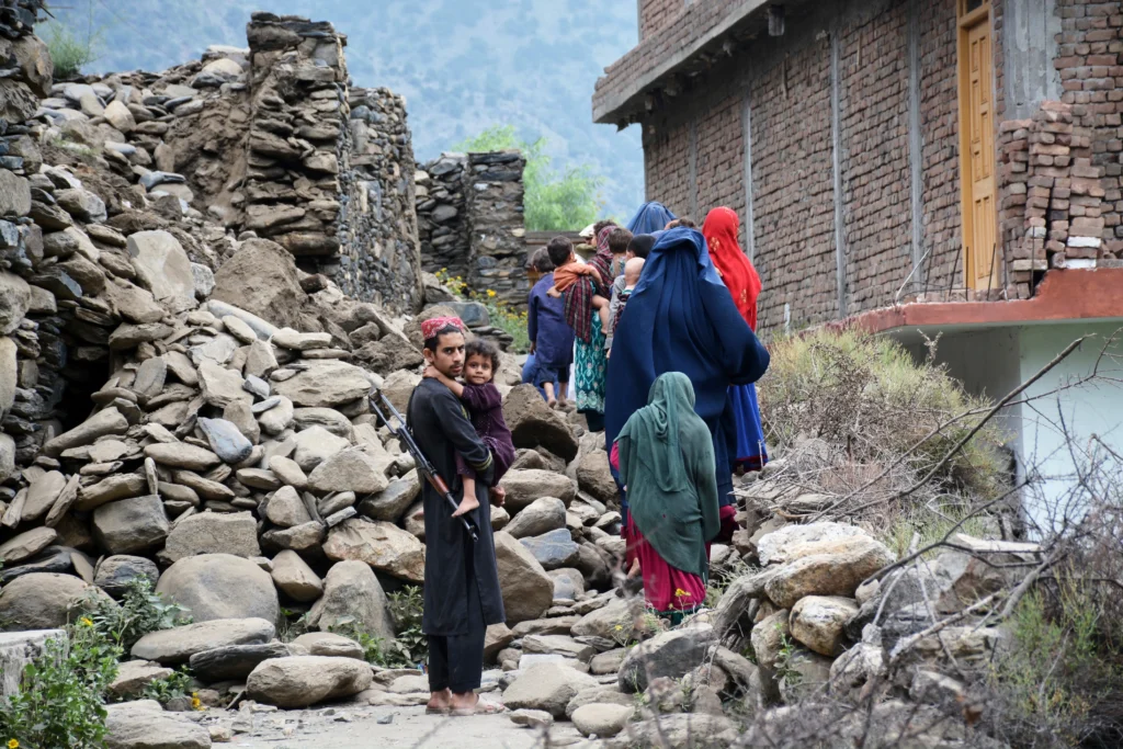 Pakistan News Beat: Pakistan's No 1 News Publisher Local residents walk by a house destroyed by the earthquake in Mazar Dara, Kunar province, Afghanistan